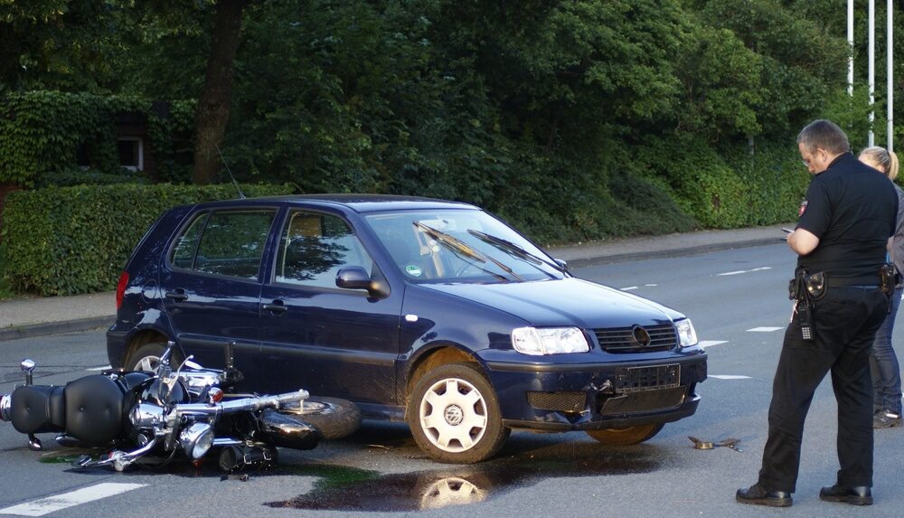 Motorcycle accident in RI with motorcycle laying on road with police around it and damage to the motorcycle