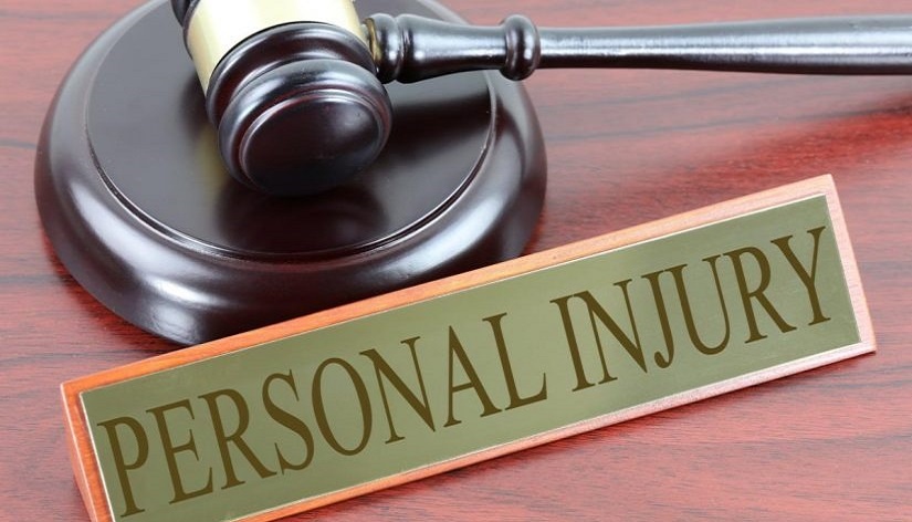 Gold and brown gavel in back of a nameplate saying Personal Injury