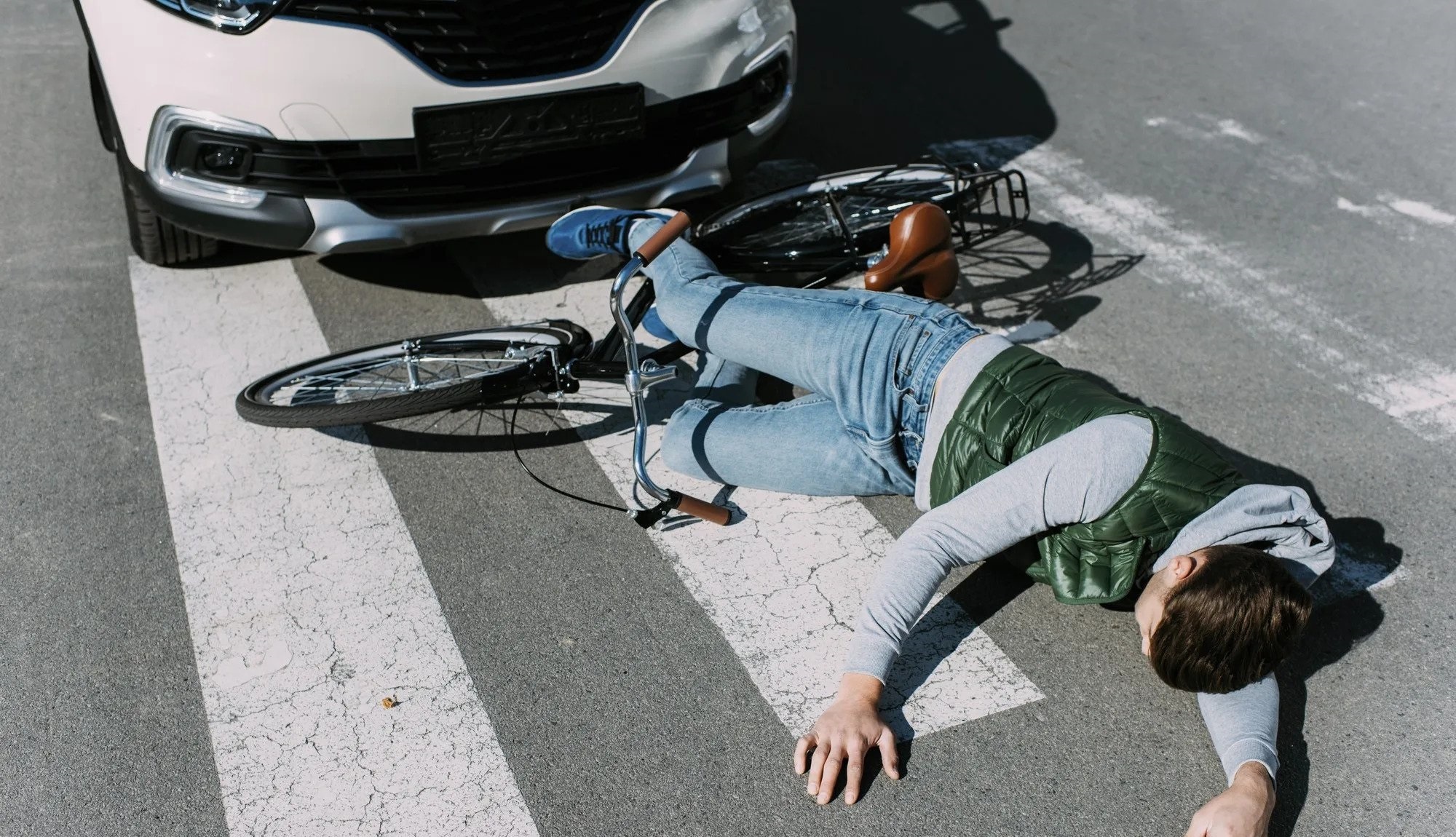 man laying on the ground after being hit by a rhode island motorist in a Rhode Island bicycle accident