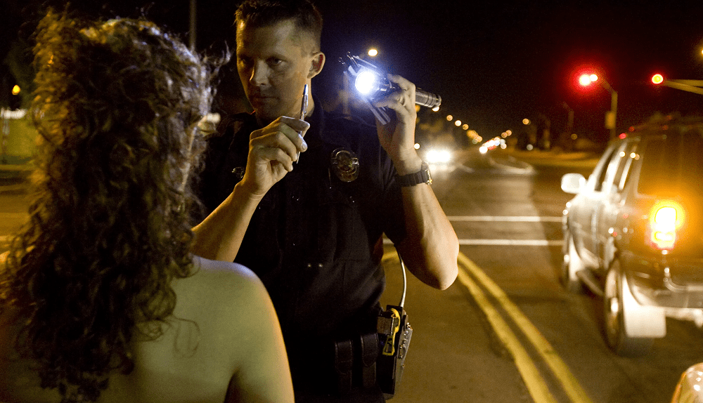 A rhode island police officer arresting a woman for a Rhode Island DUI