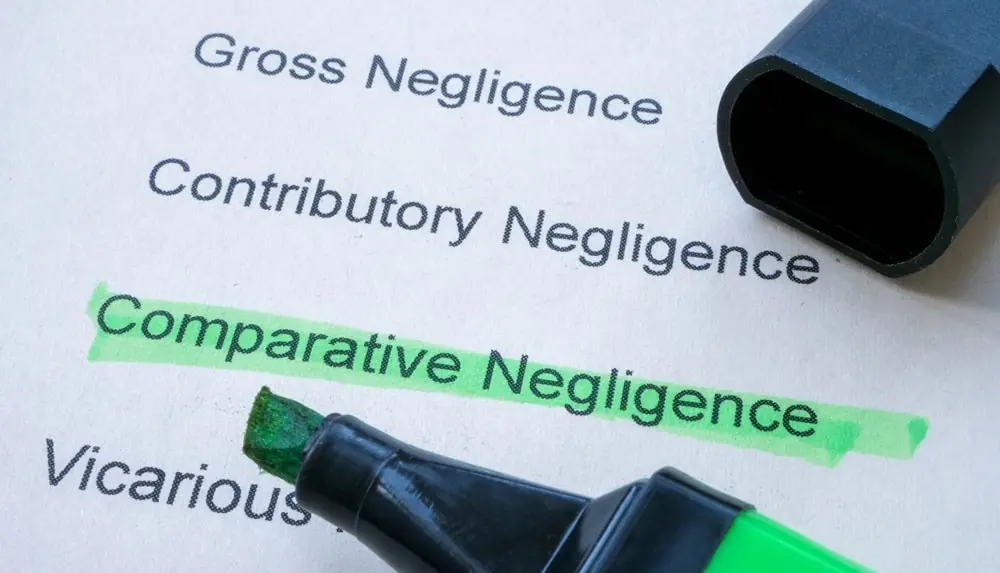 lawyer highlighting the words "comparative negligence" which is under "contributory negligence"