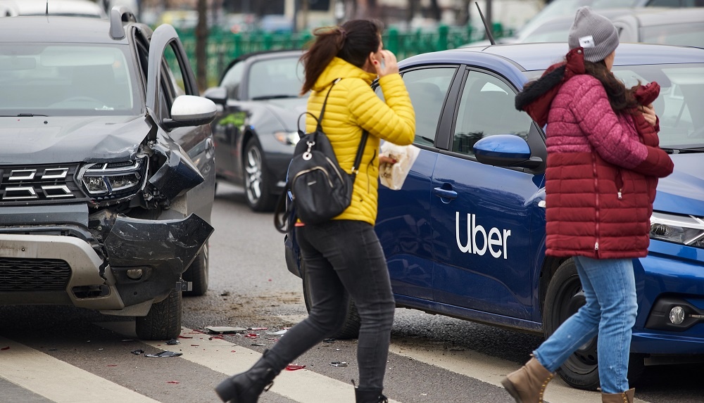 Rideshare accident in Rhode Island on a main street with people watching