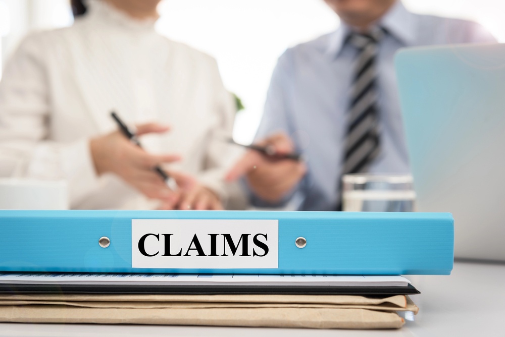 insurance claims folder sitting on insurance adjusters' desk