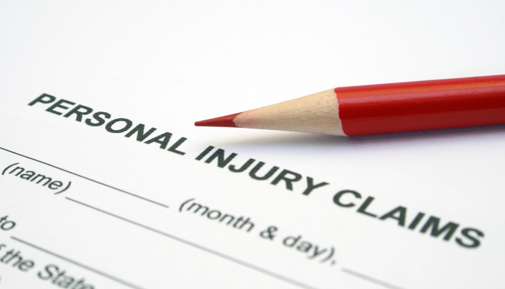 Personal injury claim form with red pencil on it